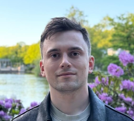 professional business portrait of Przemysław Bitkowski, male software architect, wearing business casual attire, confident pose, neutral background